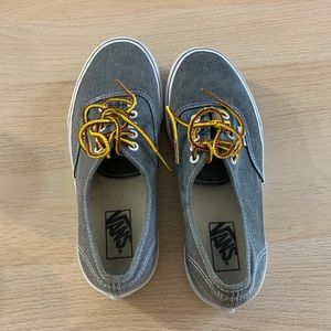 Grey vans with yellow laces